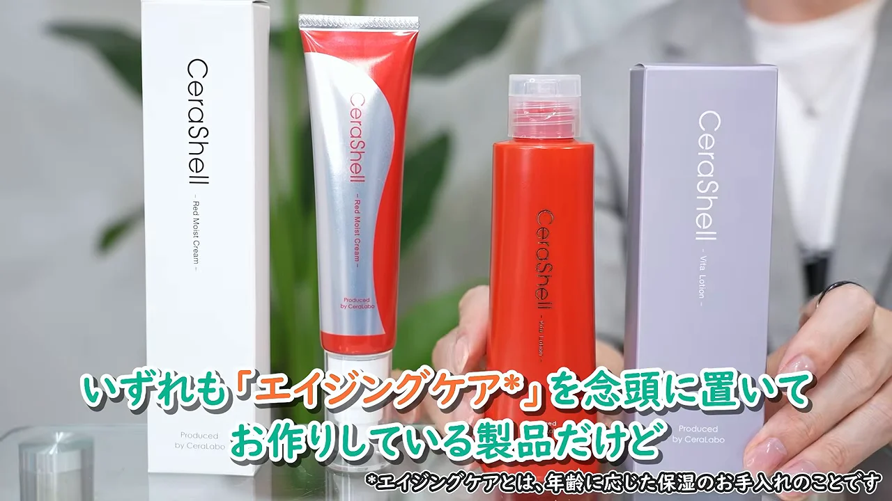テーブルの上に並べられた化粧品ボトルとチューブ、およびそれぞれの外箱を両手で紹介している様子。