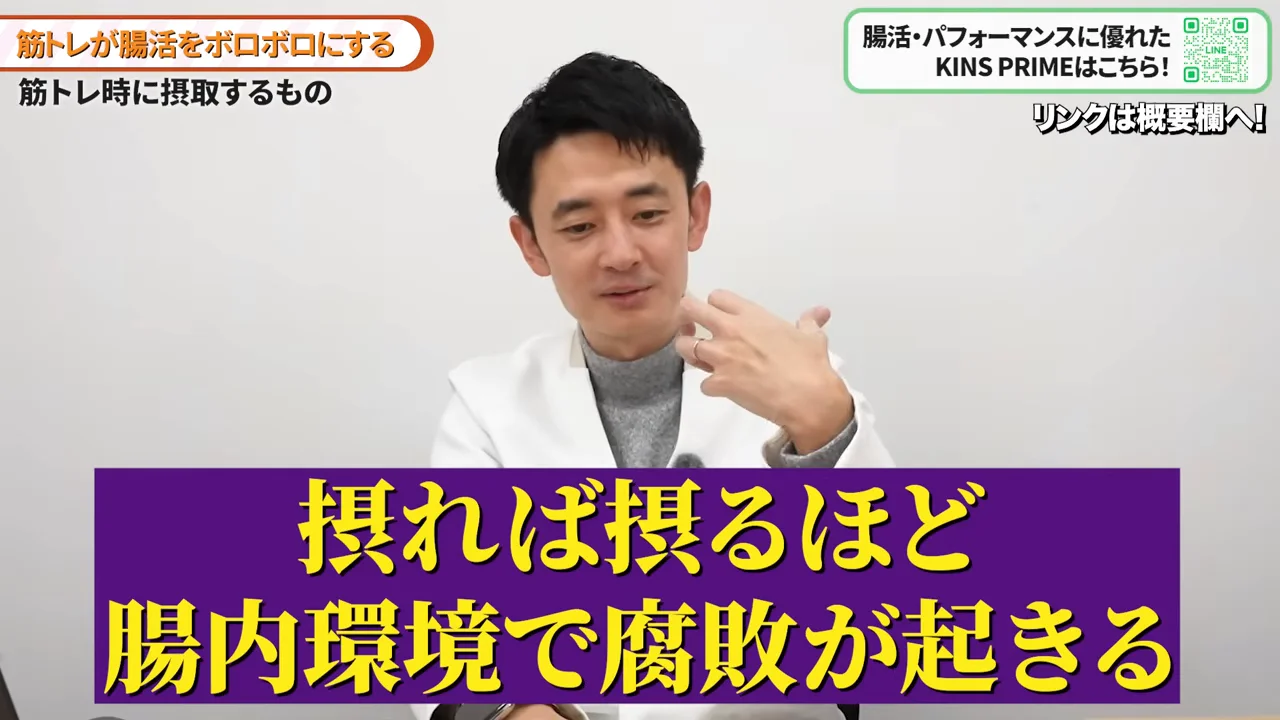 白衣を着た男性が手振りを交えながらカメラに向かって話しています。