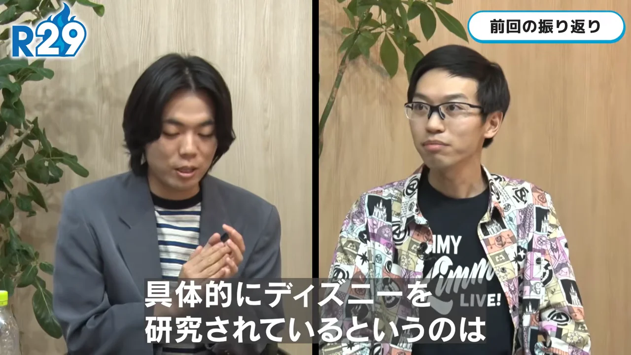 画面が2分割され、左側の男性と右側の眼鏡をかけた男性が並んで座っている様子